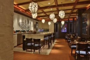 伯利恒Wind Creek Bethlehem Casino & Resort的餐厅设有酒吧,配有椅子和灯