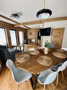 CzerwienneKanylosek Luksusowe Domki Drewniane的一间带木桌和椅子的用餐室