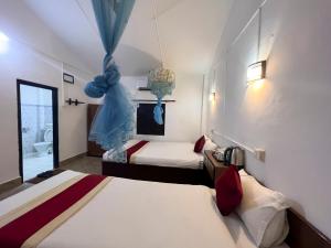 索拉哈Ama Garden Sauraha的酒店客房带两张床和一间浴室