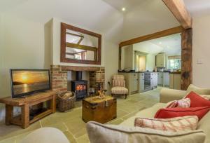 HenfieldHope Cottage - West Sussex的客厅设有壁炉和电视。