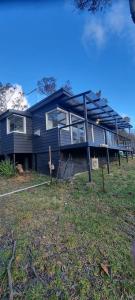 卢拉Treetop Leura Deluxe Family Cabin的蓝色的房子,有很多窗户