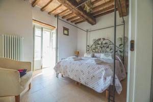 乌尔比诺Ca' Gulino - Urbino - Villa con Minipiscina in Borgo Antico的一间卧室配有一张带锻铁床头板的床