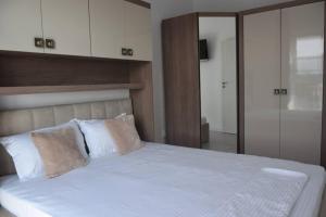 普洛耶什蒂Real Residence -apartament cu 3 camere- Valeni 144的卧室配有一张带白色床单和枕头的大床。