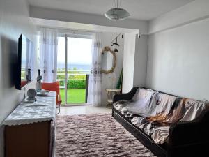 PampatarBel appartement sur l'île de Margarita, avec vue sur la mer的带沙发和电视的客厅