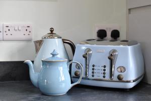 克雷尔The Old Stables- charming cottage Crail的茶壶和台面上的烤面包机