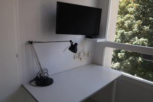 格勒诺布尔Studio Gare, Europole的客房设有一张带电视和台灯的书桌。