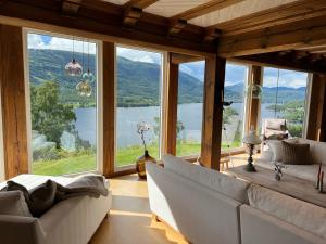 Noresund"SoFly Lodge", Charm and Elegance的带沙发和大窗户的客厅
