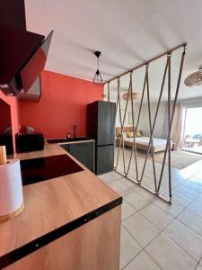 法兰西堡Bella Apartment的一间带红色墙壁的厨房和一间带柜台的厨房