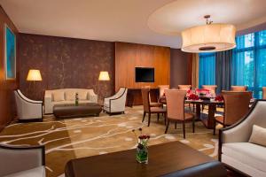 惠州惠州白鹭湖雅居乐喜来登度假酒店的一间带用餐区的客厅和一间带沙发的客厅