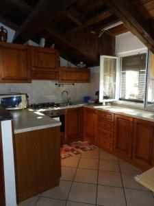 卡萨尔扎利古雷Gala的厨房配有木制橱柜、水槽和窗户。