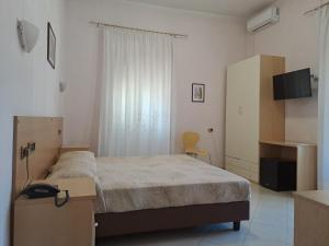 真扎诺-迪罗马洛比尼亚公寓的一间卧室配有一张床和一台电视