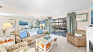 大洋城海洋时代公寓的客厅配有沙发和桌子