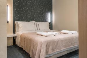 地拉那Piazza Luxury Apartments的一间卧室配有一张床,上面有两条毛巾