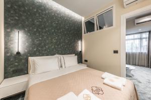 地拉那Piazza Luxury Apartments的一间卧室设有一张床和绿色的墙壁