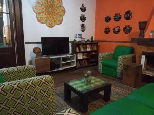 蒙得维的亚Casa Copada的客厅配有电视、沙发和桌子