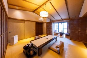 热海Taiseikan的一间用餐室,在房间内配有桌椅