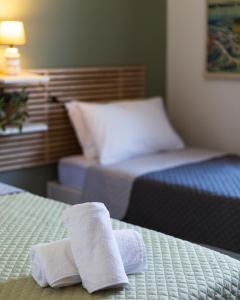 雅典Vivid Stays Petralona的酒店客房的两张床上配有2条毛巾