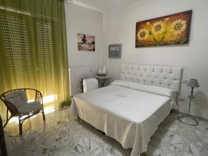 马蒂纳塔Orchidea Mattinata parco del Gargano的卧室配有白色的床和椅子