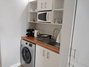 圣弗朗西斯湾Ships Bell 17B的厨房配有洗衣机和微波炉。