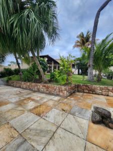 马里卡Casa na Lagoa的棕榈树庭院和石墙