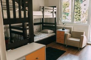 贝尔格莱德Smart hostel的小型客房配有双层床和椅子。