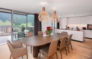 英格堡Swiss Hotel Apartments - Engelberg的厨房以及带桌椅的用餐室。
