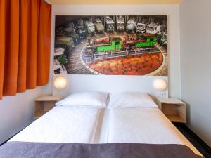 奥格斯堡B&B Hotel Augsburg-Süd的墙上画画的房间里设有两张床