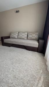 瓦尔米耶拉Z - apartment的一张沙发,位于一间铺有地毯的房间的角落