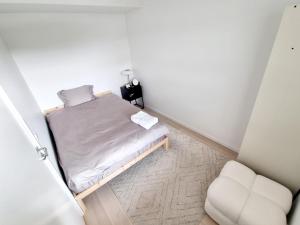 奥斯陆Private room in shared Modern Apartment - Oslo Hideaway的一间小卧室,配有一张床和一把椅子