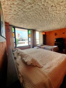 派帕HOTEL COMPOSTELLA的一间卧室设有一张大床和大窗户