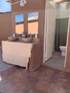 乌玛瓦卡Buena Vista Hostel的一间带两个盥洗盆和卫生间的浴室