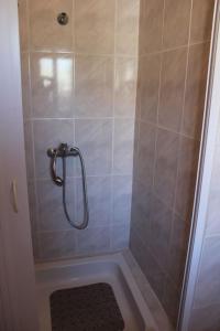 ErvedalMorgado Guest House的一间带淋浴的浴室和瓷砖墙