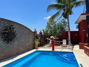 PérulaCasa Punta Perula VILLAS的一座房子旁边的游泳池,里面装有红色消防栓
