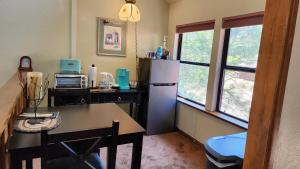 奥克赫斯特Yosemite Mountain Retreat的厨房配有冰箱、桌子和窗户。