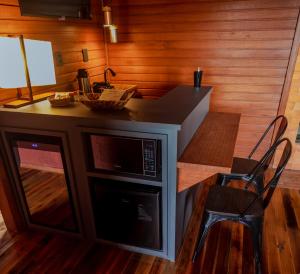 圣若阿金Vinícola D'alture - Cabana Casal -的厨房配有微波炉、桌子和椅子