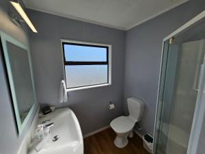 北帕默斯顿庄园汽车旅馆的一间带水槽和卫生间的浴室以及窗户。