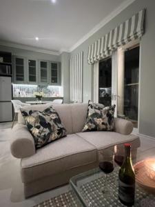 开普敦Two on Milner - OAK TREE COTTAGE - Stylish open-plan Guesthouse in Rondebosch的客厅配有沙发和桌子