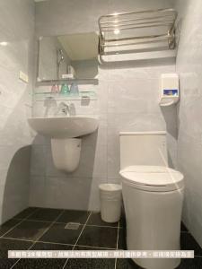 台中市达斯旅店的白色的浴室设有卫生间和水槽。