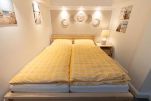 汉堡Neue zentrale Souterrain-Wohnung 24h Self Check-In的一间卧室配有一张黄色棉被的床