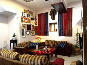 Bayt SāḩūrBeit Zaman hostel的客厅配有两张沙发和一张桌子