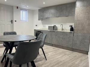 卢顿Apartment In Luton Town Centre的厨房以及带桌椅的用餐室。