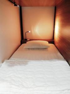 芹苴Adora Dorm Bed with Balcony in the Center的一张带白色枕头的床