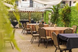 迦太基萨尔瓦多古阿可酒店餐厅的庭院里的一组桌椅