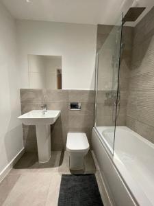 谢菲尔德Stylish and Modern 2BR Apartment with Parking的浴室配有卫生间、盥洗盆和淋浴。