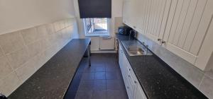 巴恩斯利APARTMENT IN CENTRAL BARNSLEY的一个带水槽和柜台的小厨房