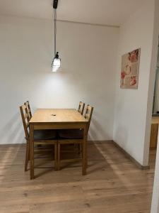 洛伊克巴德Haus Atlantic Leukerbad的餐桌,配有两把椅子和一盏灯