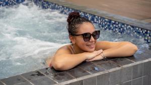 帕拉马里博Torarica Resort的戴太阳镜的游泳池里的女人