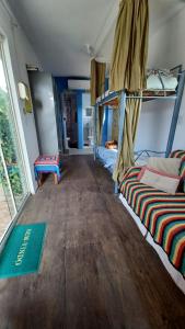 托雷斯Hostel Tribos Livres的客房设有两张双层床,铺有木地板。