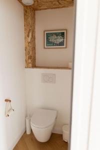 PloudalmézeauMen Louet E - Gîte de bord de mer的一间带卫生间的浴室和墙上的照片