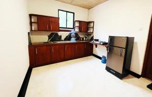 阿鲁特伽马Nature Bliss Villa的厨房配有冰箱和木制橱柜。